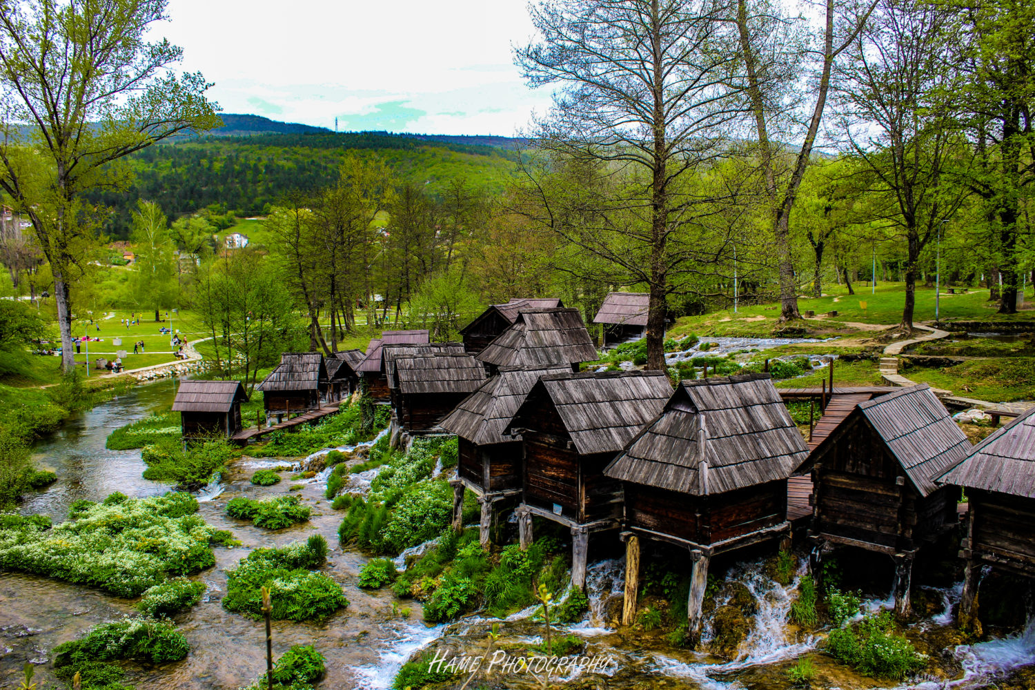 Wooden watermills on Pliva River surrounded by greenery in Jajce, Bosnia and Herzegovina
