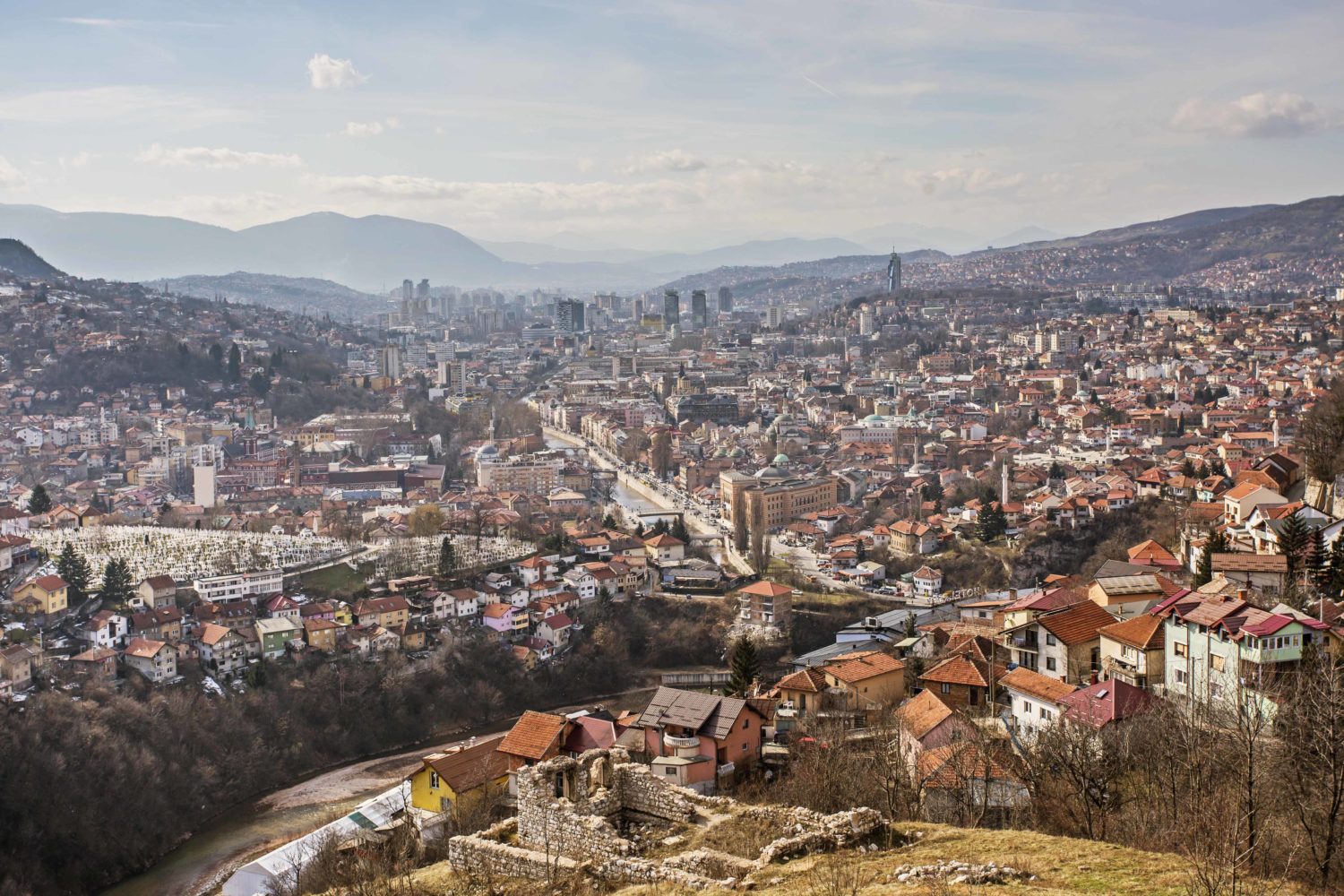 Panoramic view of Sarajevo with the city's skyline and surrounding mountains by Dženat Dreković