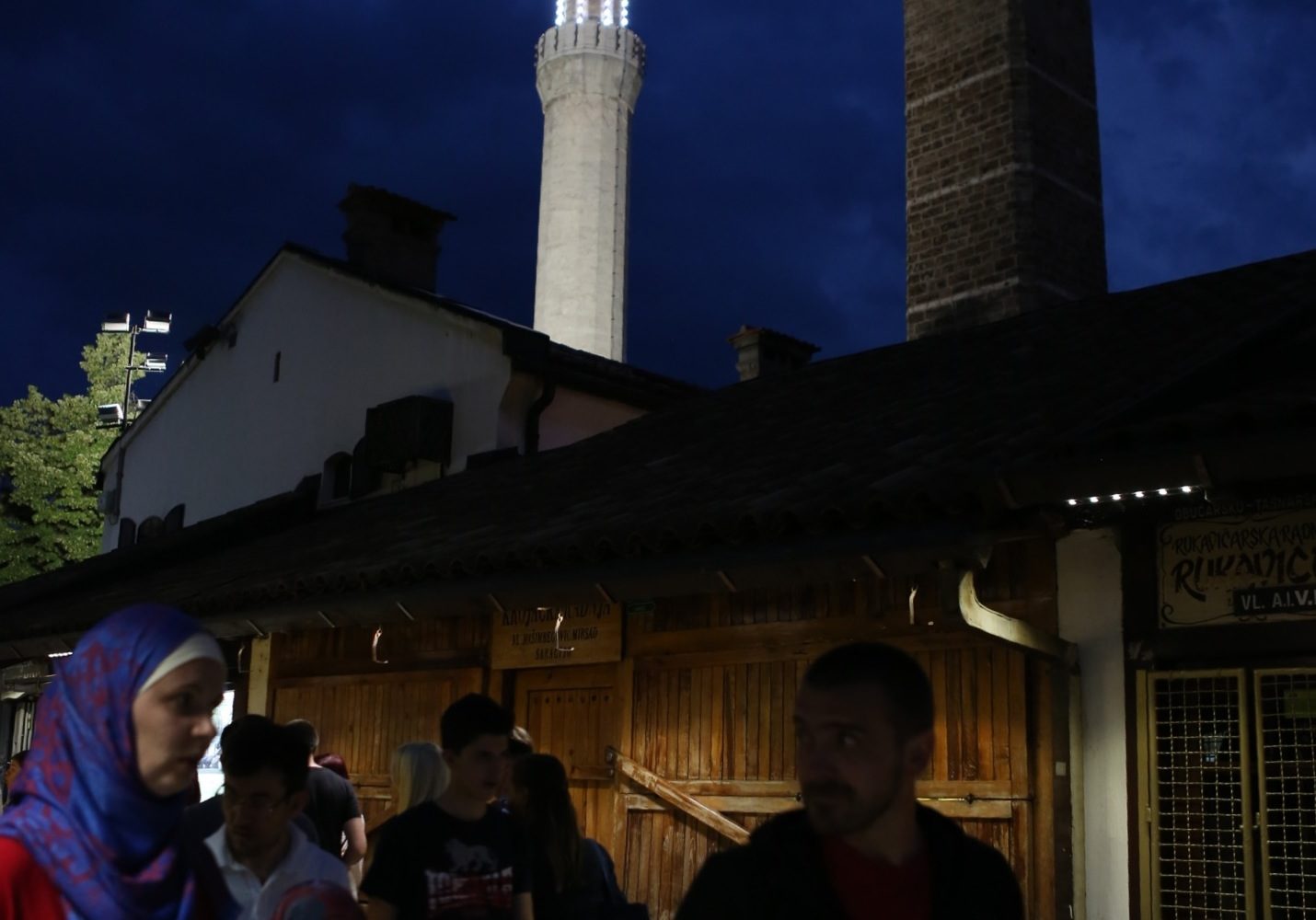 People walking in front of a mosque at night during a Sarajevo Insider tour