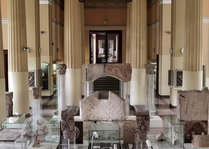 Interior of the National Museum of Bosnia and Herzegovina showcasing ancient artifacts and columns
