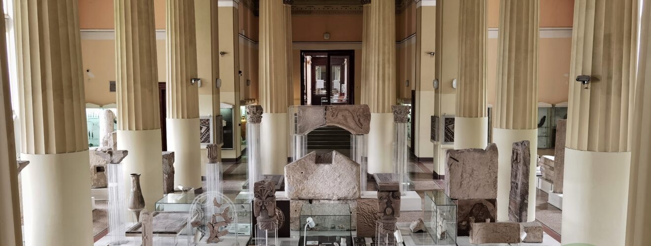 Interior of the National Museum of Bosnia and Herzegovina showcasing ancient artifacts and columns