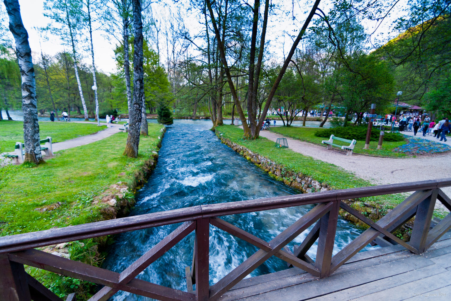 Scenic view of Vrelo Bosne with clear blue waters and lush greenery