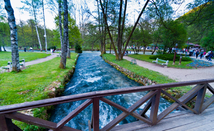 Scenic view of Vrelo Bosne with clear blue waters and lush greenery