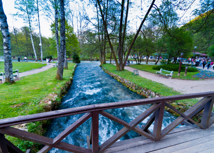 Scenic view of Vrelo Bosne with clear blue waters and lush greenery