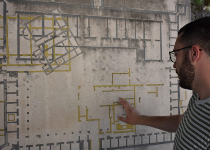 Tour guide explaining a historical map at a site in Sarajevo.