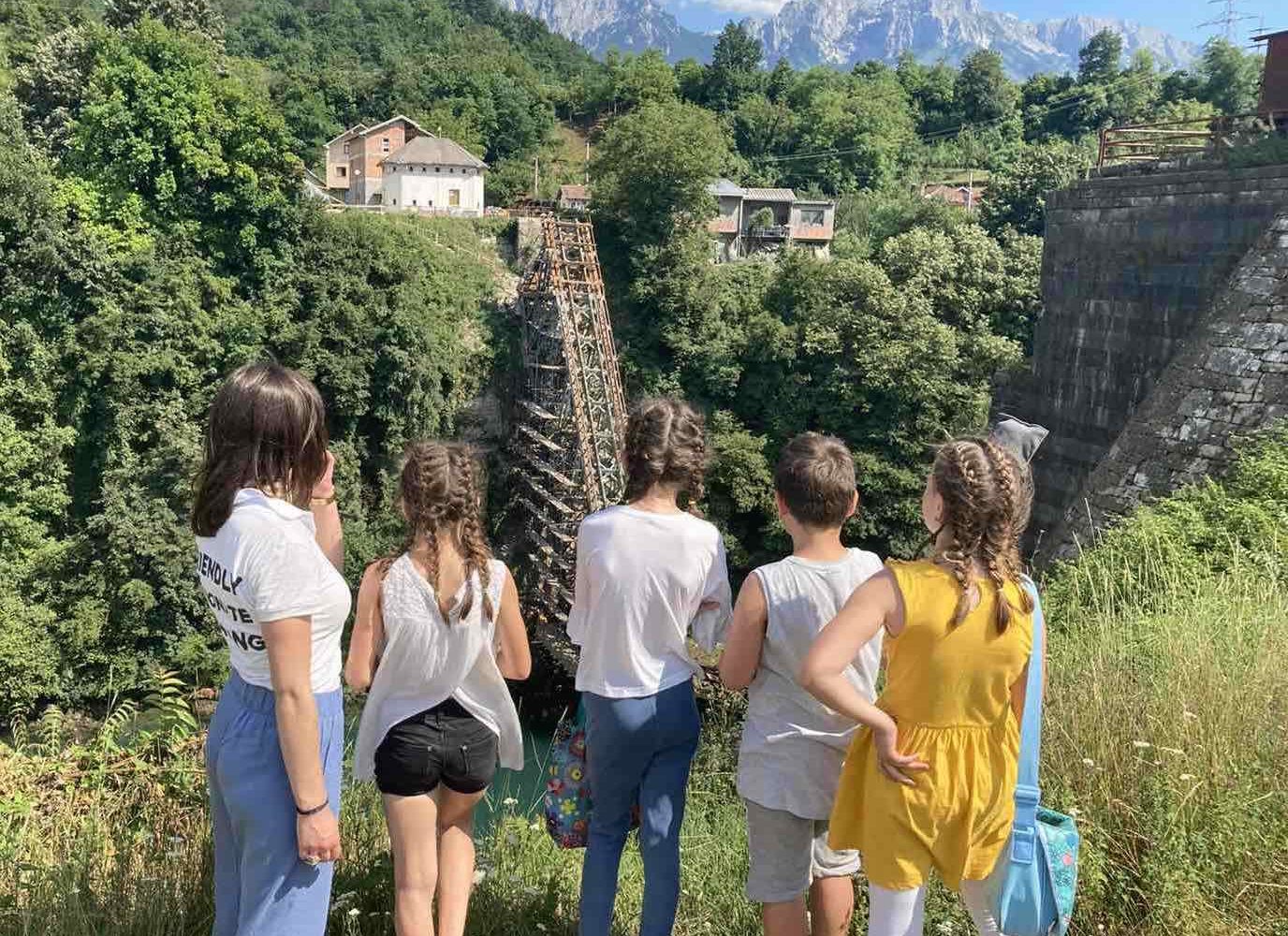 Children observing the historical bridge in Jablanica, Bosnia and Herzegovina, which played a crucial role in World War II.